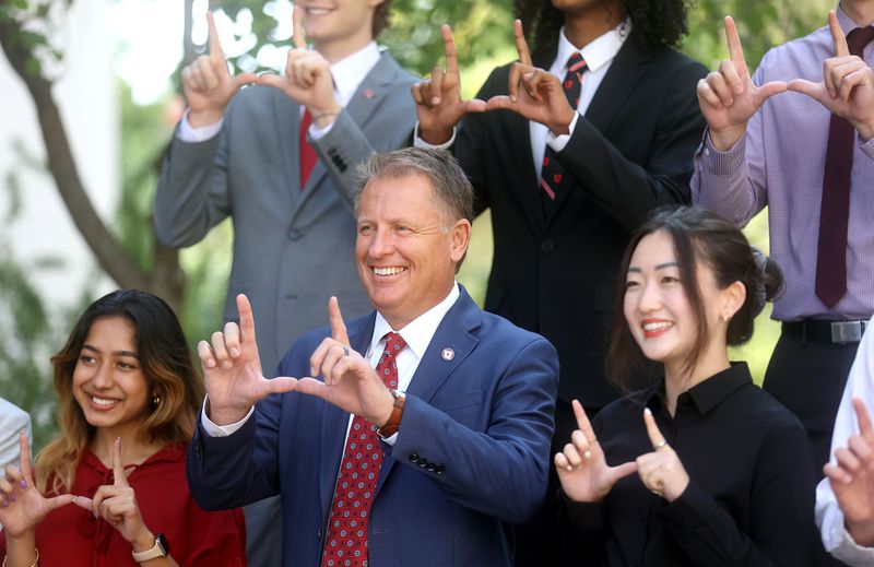 University of Utah President Taylor Randall, center,
makes a "U” sign while posing for a photo with presidential interns
at the University of Utah in Salt Lake City on Aug. 20. Sanila Math is on the left and Jaina Lee is on the
right.