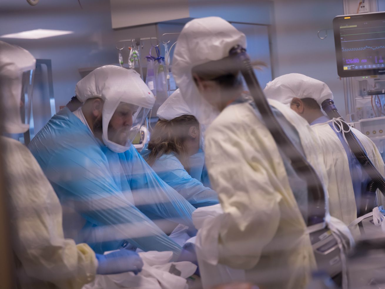 Health care workers treat patients inside the medical intensive care unit at University of Utah Hospital on July 30. Gov. Spencer Cox spent several hours this week meeting with lawmakers on how to reduce Utah's strained hospital capacity amid the state's COVID-19 surge.