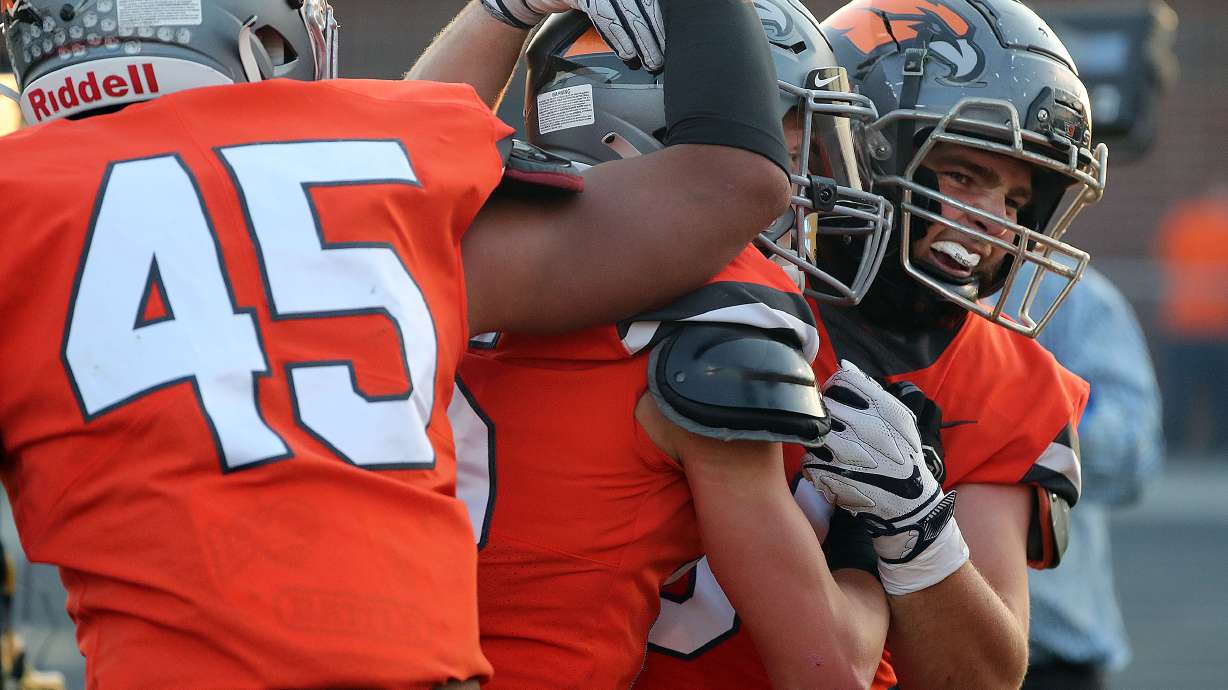 Skyridge players celebrate Jace Doman's interception and touchdown during a high school football game against Orem at Skyridge High School in Lehi on Friday, Sept. 3, 2021. Skyridge won 36-0.