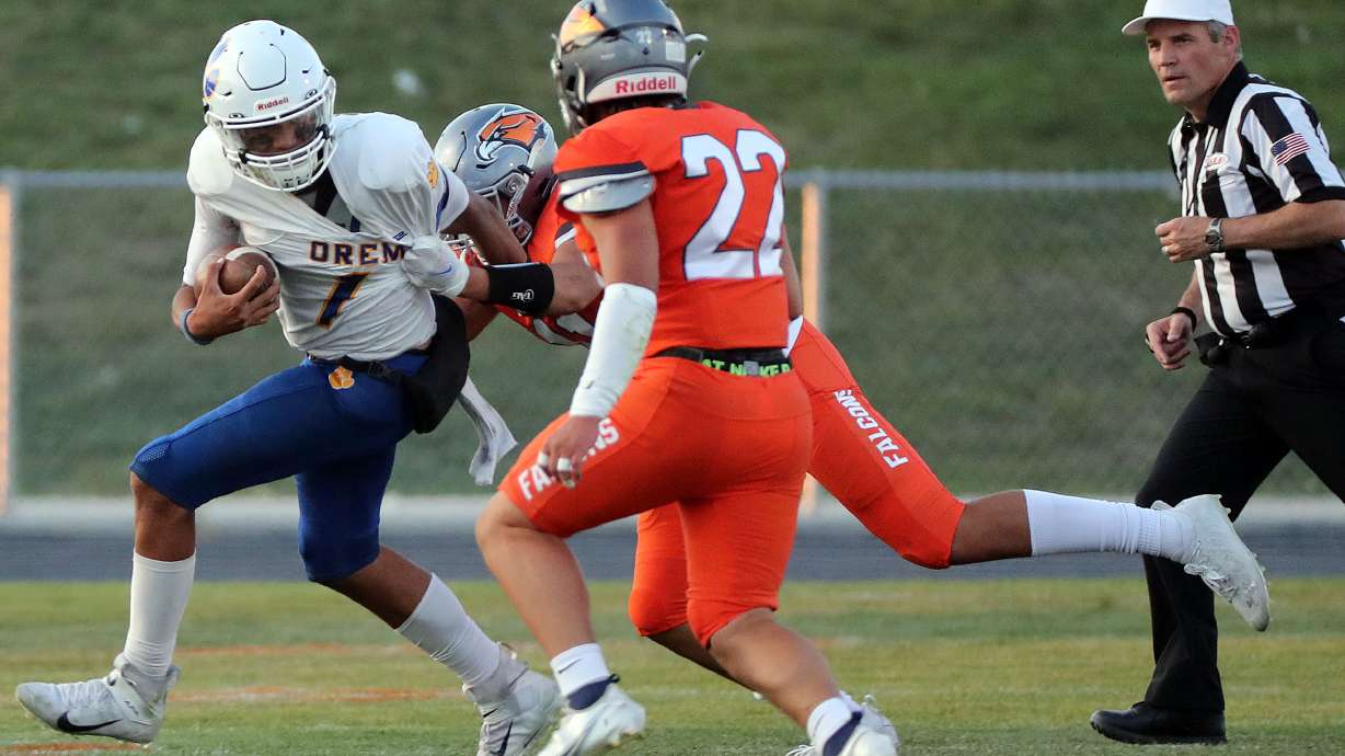 Orem's Chase Tuatagaloa gets tackled by Skyridge's Sione Westover and Tayton Hiatt during a high school football game at Skyridge High School in Lehi on Friday, Sept. 3, 2021. Skyridge won 36-0.