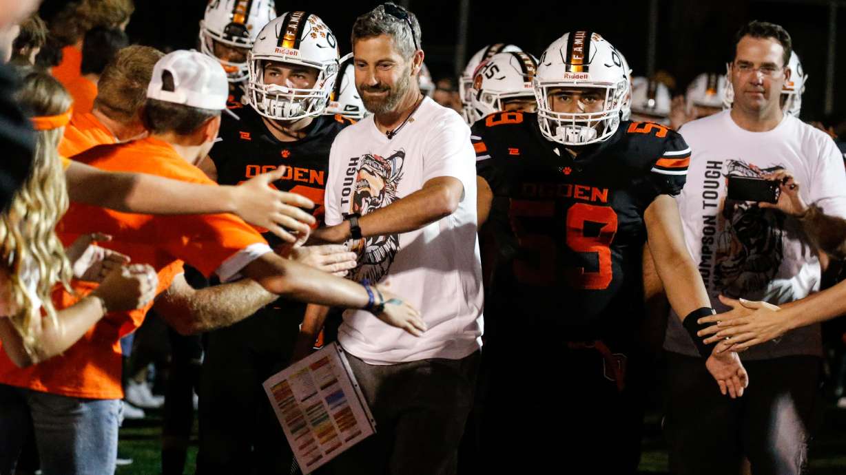 Ogden football coach Erik Thompson, who was recently diagnosed with Lou Gehrig's disease, celebrates with his supporters during a high school football game billed as Erik Thompson Night on Friday, Sept. 3, 2021, at Ogden High School in Ogden.