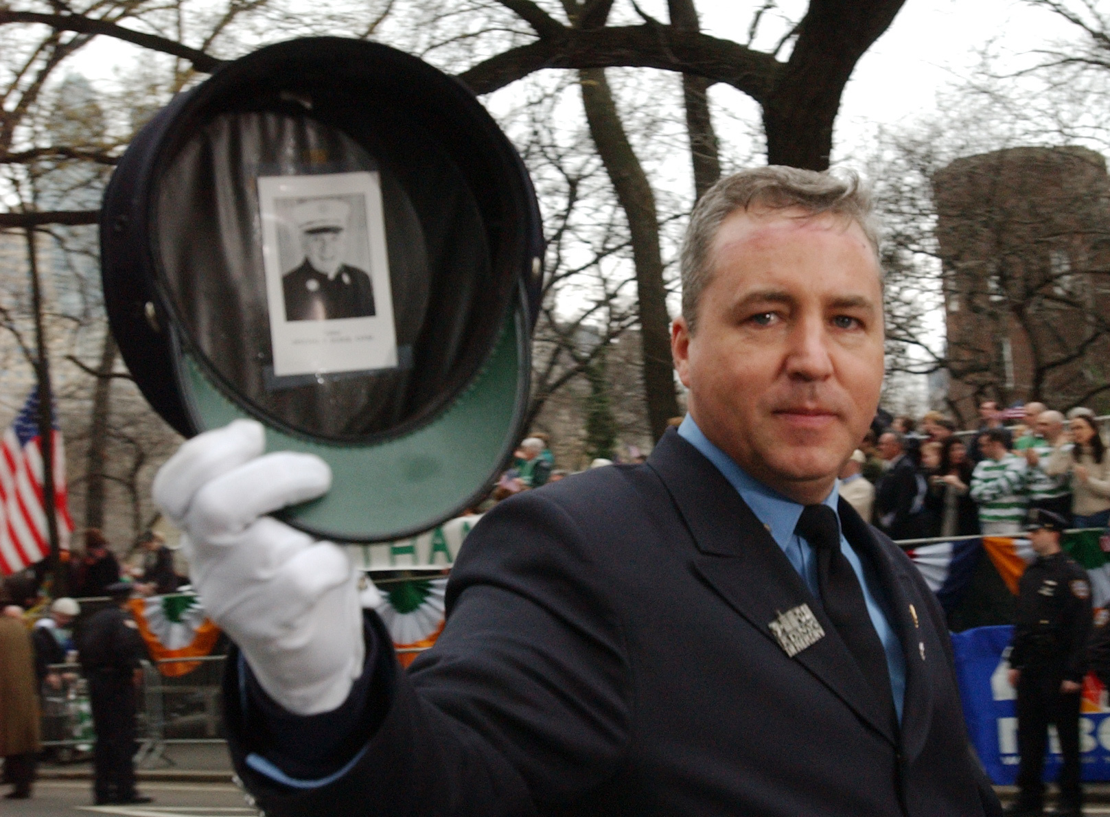 Firefighter Dan Walker displays a photo of Father Mychal Judge taped inside his hat during the 241st St. Patrick's Day Parade in New York.
