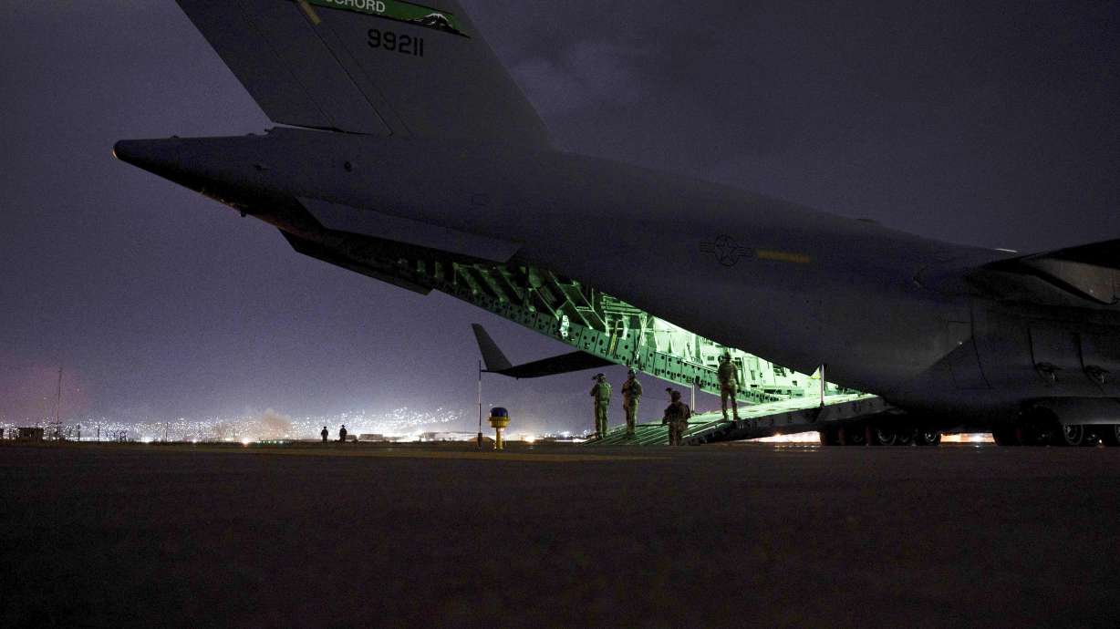 An Air Force aircrew, assigned to the 816th Expeditionary Airlift Squadron, prepares to receive soldiers, assigned to the 82nd Airborne Division, to board a U.S. Air Force C-17 Globemaster III aircraft in support of the final noncombatant evacuation operation missions at Hamid Karzai International Airport in Kabul Afghanistan in August.