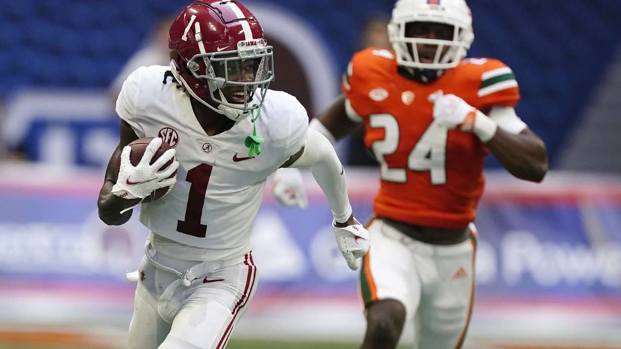 Alabama wide receiver Jameson Williams (1) runs away from Miami safety Kamren Kinchens (24) for a touchdown after a catch in the second half of an NCAA college football game Saturday in Atlanta.