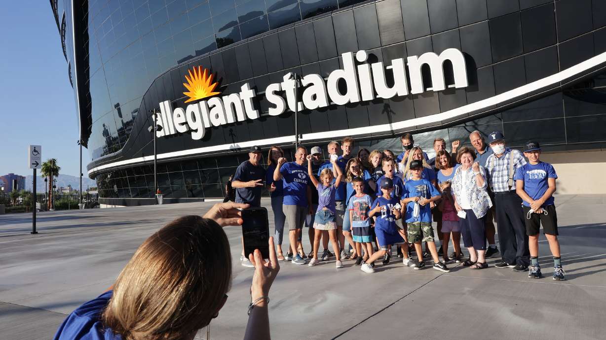 BYU fans take photos outside the Allegiant Stadium prior to the Vegas Kickoff Classic between BYU and Arizona in Las Vegas on Saturday, Sept. 4, 2021.