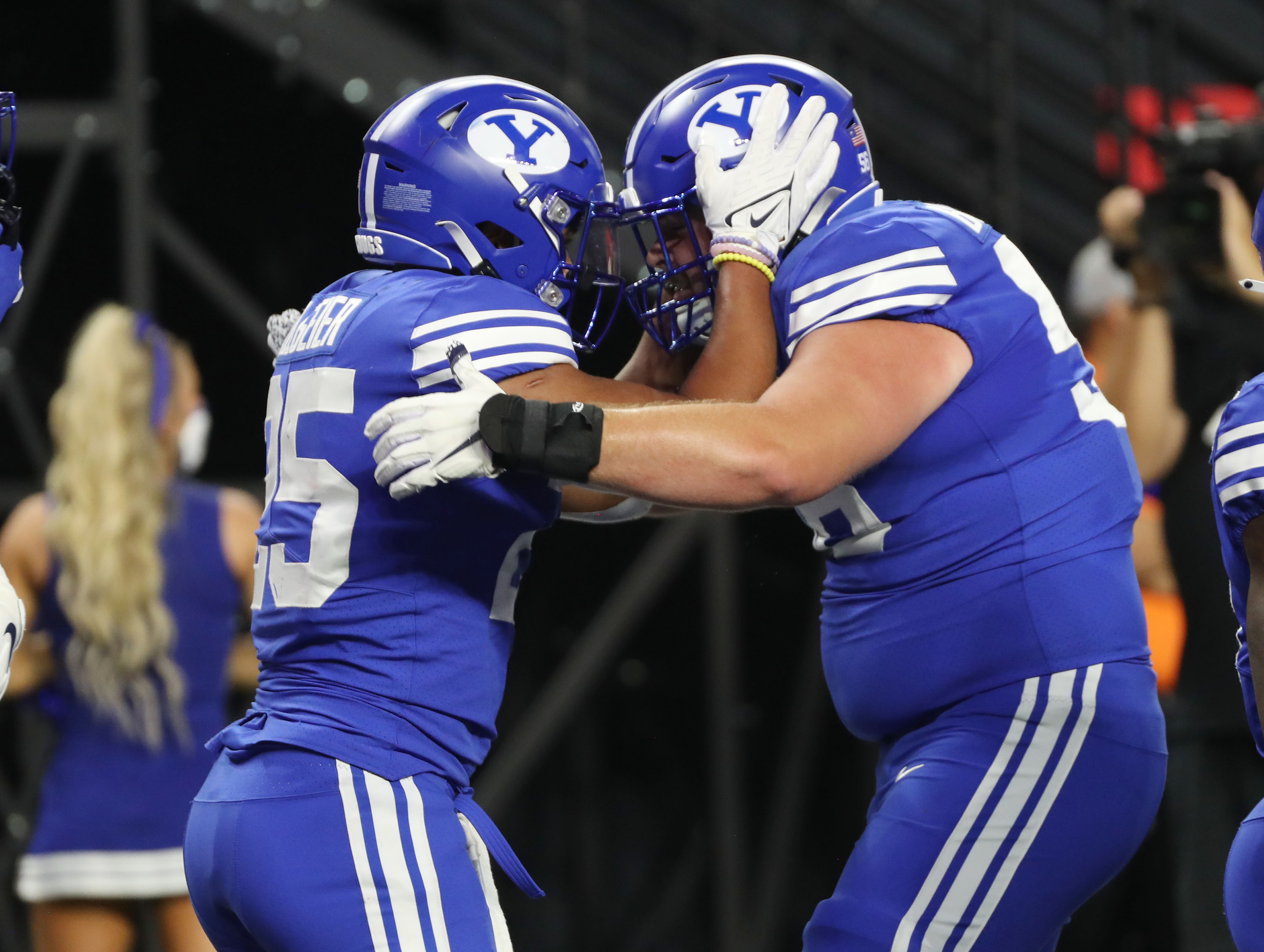 Brigham Young Cougars running back Tyler Allgeier (25)  celebrate his touchdown with Brigham Young Cougars defensive lineman Uriah Leiataua (58) during the Vegas Kickoff Classic in Las Vegas on Saturday, Sept. 4, 2021.