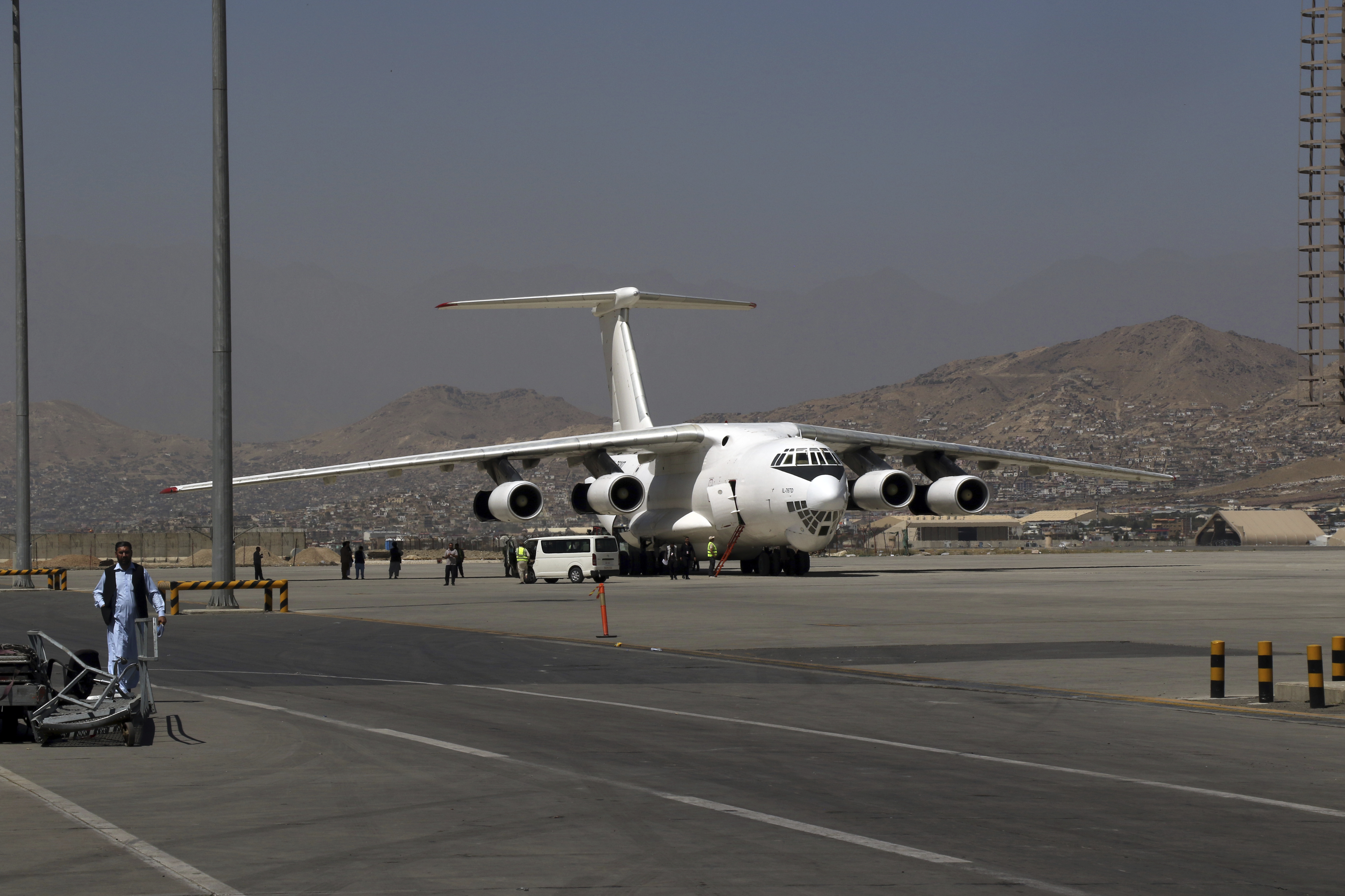 A plane is parked at Hamid Karzai International Airport in Kabul, Afghanistan, Sunday. Some domestic flights have resumed at Kabul's airport, with the state-run Ariana Afghan Airlines operating flights to three provinces.