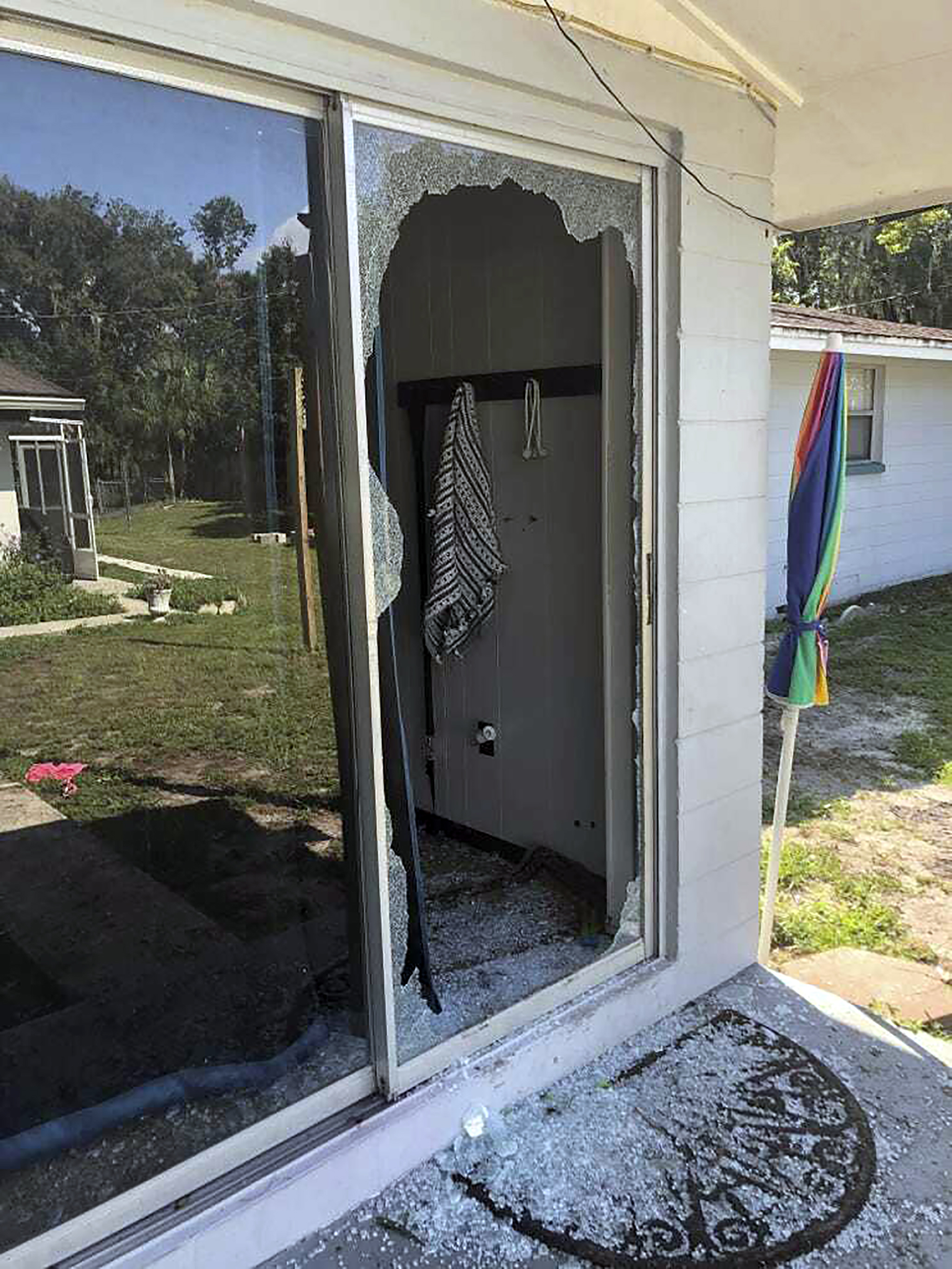 This image provided by the Polk County Sheriff's Office shows the back of the residence where a Polk sheriff's lieutenant entered the house and exchanged fire with a shooting suspect in a neighborhood in Lakeland, Fla. Four people are dead including a mother who was still cradling her now-deceased baby in what Florida sheriff's deputies are calling a massive gunfight early Sunday with a suspect they said was “ready for battle.” 
