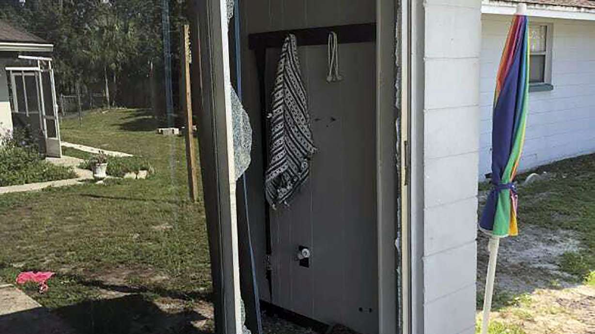 This image provided by the Polk County Sheriff's Office shows the back of the residence where a Polk sheriff's lieutenant entered the house and exchanged fire with a shooting suspect in a neighborhood in Lakeland, Fla. Four people are dead including a mother who was still cradling her now-deceased baby in what Florida sheriff's deputies are calling a massive gunfight early Sunday with a suspect they said was “ready for battle.”