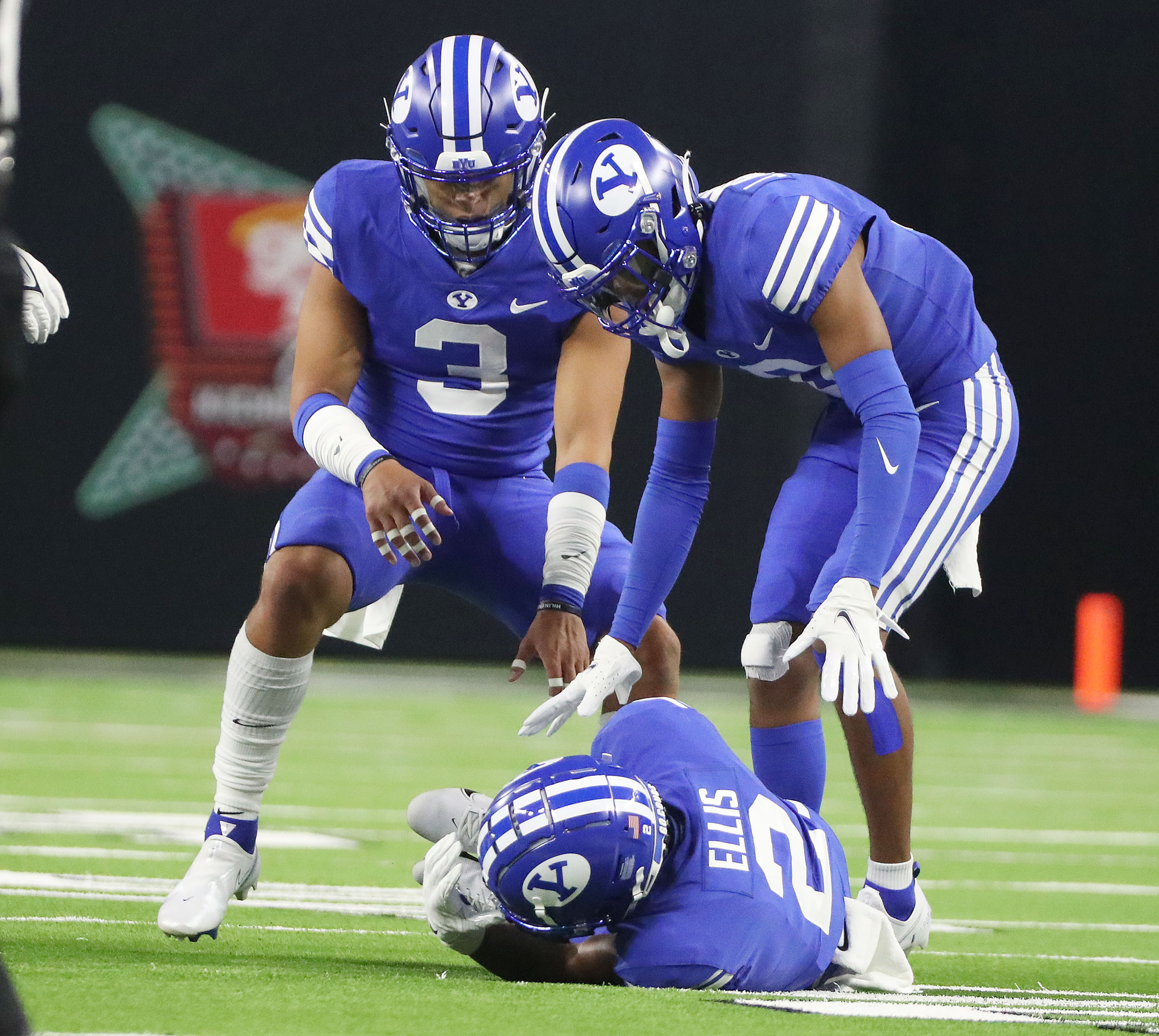 BYU teammates check on Brigham Young defensive back Keenan Ellis (2) after a "scary" injury during the Vegas Kickoff Classic in Las Vegas on Saturday, Sept. 4, 2021.