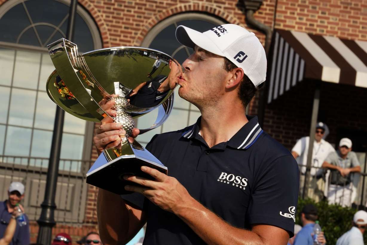 Patrick Cantlay kisses the trophy after winning the Tour Championship golf tournament and the FedEx Cup at East Lake Golf Club, Sunday, Sept. 5, 2021, in Atlanta.