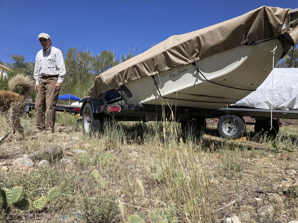 Tom Wiersema, who has been trout fishing on the upper North Platte River in Wyoming since the 1970s, stand by his drift boat near Encampment,Wyoming on Tuesday,Aug. 24, 2021. Low water caused Wiersema to stop fishing by boat on a long stretch of the river earlier than usual this year, lest he have to drag his boat over rocks. The upper North Platte is one of several renowned trout streams affected by climate change, which has brought both abnormally dry, and sometimes unusually wet, conditions to the western U.S.