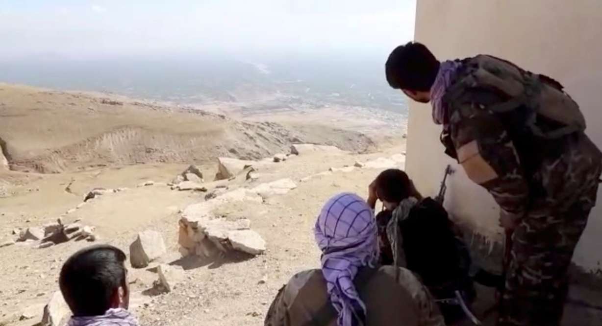 Members of National Resistance Front observe by a house near Panjshir Valley, Afghanistan in this image obtained from an undated video handout. The Taliban said on Monday they have taken control of Panjshir province north of Kabul, the Afghan capital. The province was the last holdout of anti-Taliban forces in the country.