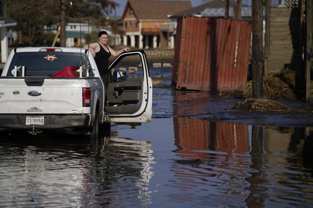 Shannon Lation checks on her home destroyed by Hurricane Ida, Sunday, in Lafitte, Louisiana. Ida slammed into the Gulf Coast at a time when building contractors were already grappling with severe shortages of workers and depleted supply chains.