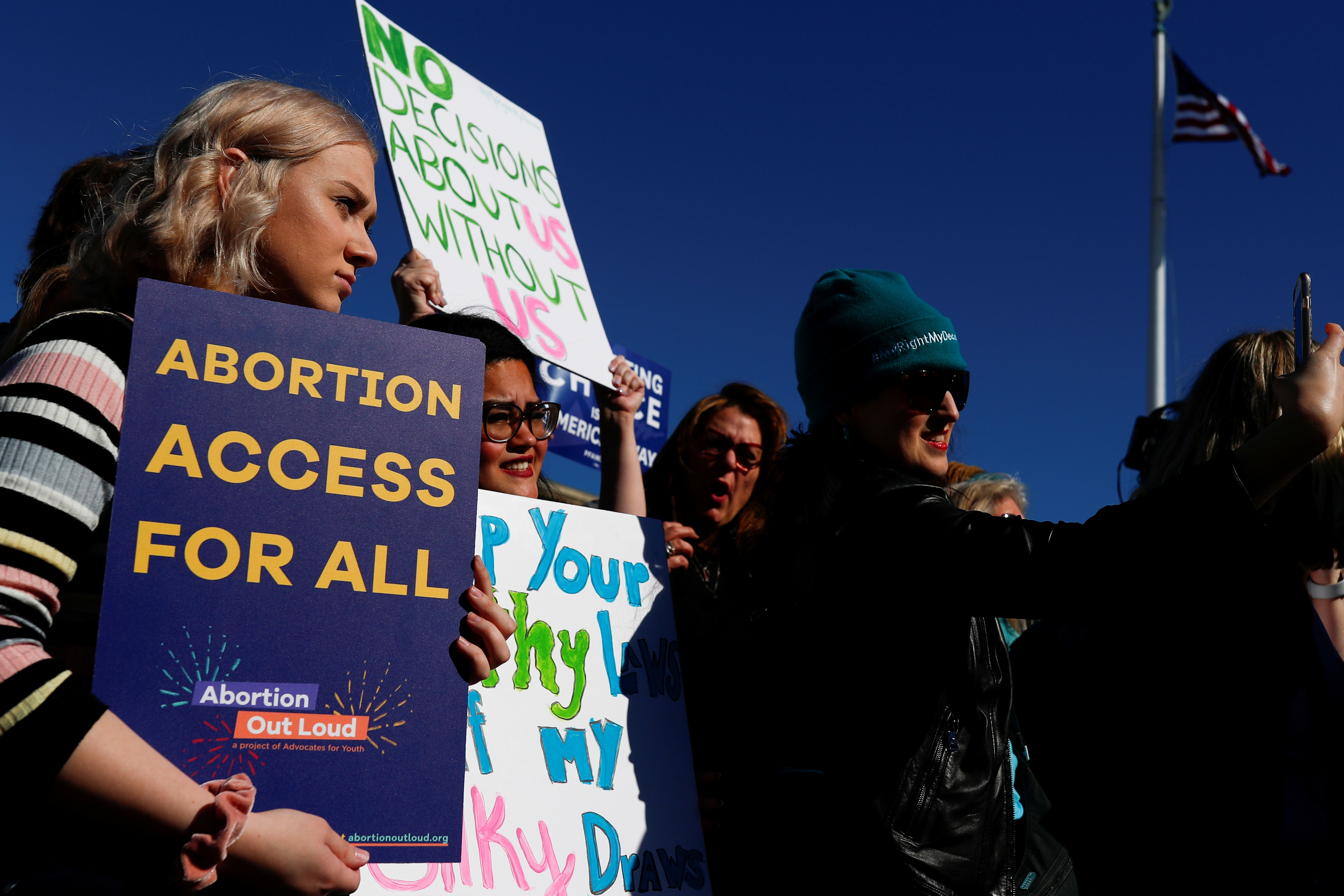 Pro-choice demonstrators hold up signs during a group chant outside of the U.S. Supreme Court as justices hear a major abortion case on Capitol Hill in Washington, in March 2020. On Sunday, a leading Democratic senator said the filibuster rule likely imperils a bill intended to protect abortion rights that Democrats are readying following the Supreme Court's decision not to block a strict new Texas ban.