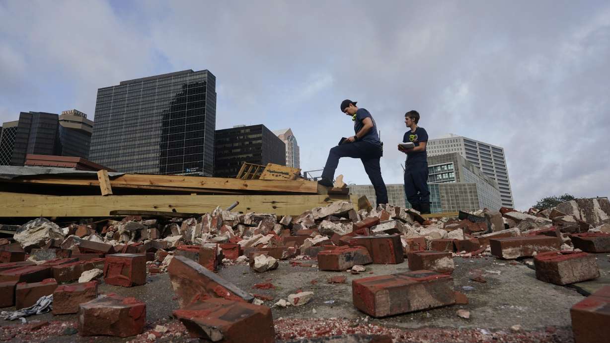 New Orleans firefighters assess damage as they look through debris after a building collapsed from the effects of Hurricane Ida, on Monday in New Orleans, Louisiana. All of New Orleans lost power around sunset Sunday as the hurricane blew ashore on the 16th anniversary of Katrina, leading to an uneasy night of pouring rain and howling wind. The weather died down shortly before dawn.