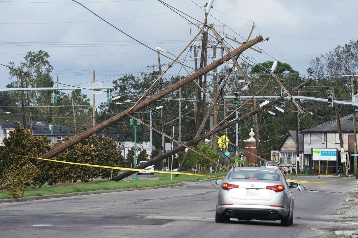 Traffic diverts around downed power lines on Monday in Metairie, Louisiana. A fearsome Hurricane Ida has left scores of coastal Louisiana residents trapped by floodwaters and pleading to be rescued, while making a shambles of the electrical grid across a wide swath of the state in the sweltering, late-summer heat. One of the most powerful hurricanes ever to hit the U.S. mainland has now weakened into a tropical storm as it pushes inland over Mississippi with torrential rain and shrieking winds.