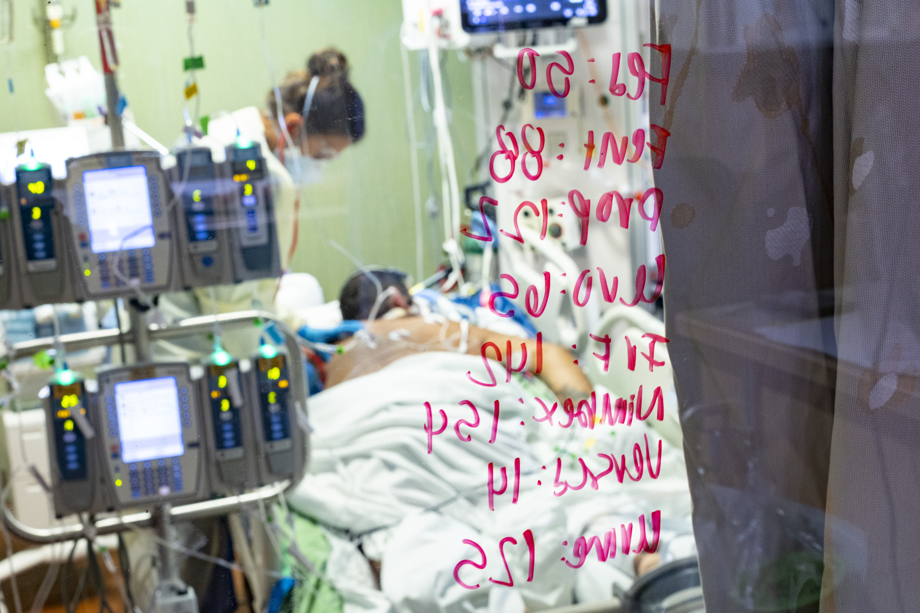 Ann Enderle R.N. checks on a COVID-19 patient at St. Luke's Boise Medical Center in Boise, Idaho, Aug. 31. Idaho public health leaders have activated "crisis standards of care" for the state's northern hospitals because there are more coronavirus patients than the institutions can handle.