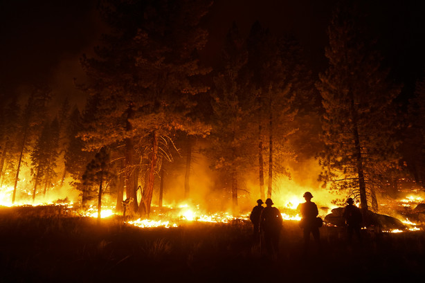 A firefighter lights a backfire to stop the Caldor Fire from spreading near South Lake Tahoe, Calif, on Wednesday, Sept. 1, 2021.
