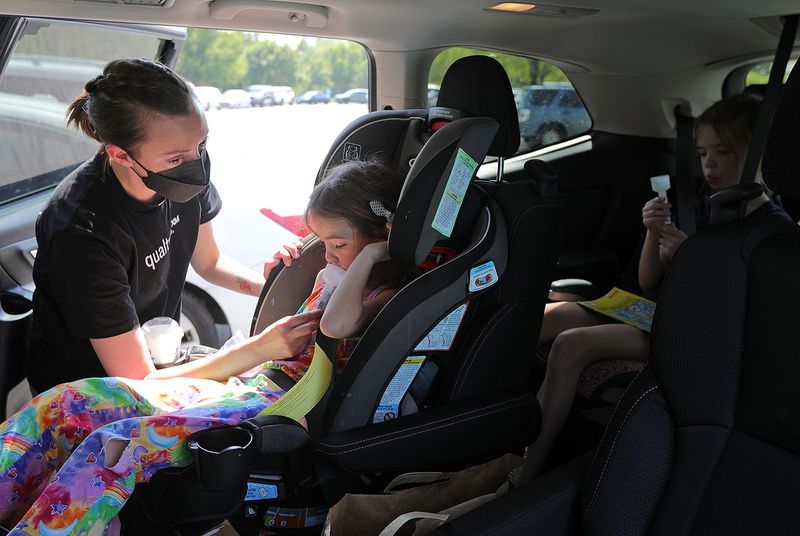 Catherine Jeppsen helps her daughters as they attempt to collect saliva for COVID-19 testing outside the Mt. Olympus Senior Center in Millcreek on Tuesday. Utah reported 1,539 new cases of COVID-19 Wednesday.