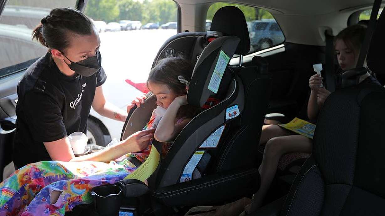 Catherine Jeppsen helps her daughters as they attempt to collect saliva for COVID-19 testing outside the Mt. Olympus Senior Center in Millcreek on Tuesday. Utah reported 1,539 new cases of COVID-19 Wednesday.