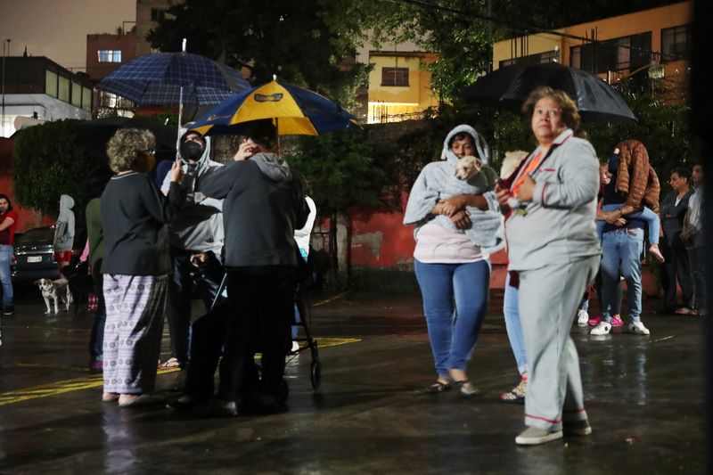 People react during an earthquake in Mexico City on Tuesday, September 7, 2021.