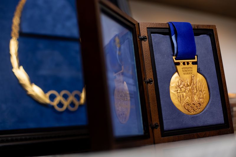 A gold medal from the 2002 Winter Olympics, right, and
the Olympic Order in Gold, which was awarded to Fraser Bullock, who
served as chief operating officer for the Salt Lake Organizing
Committee for the games, are pictured in Bullock’s home in Alpine
on Tuesday, Aug. 31, 2021.