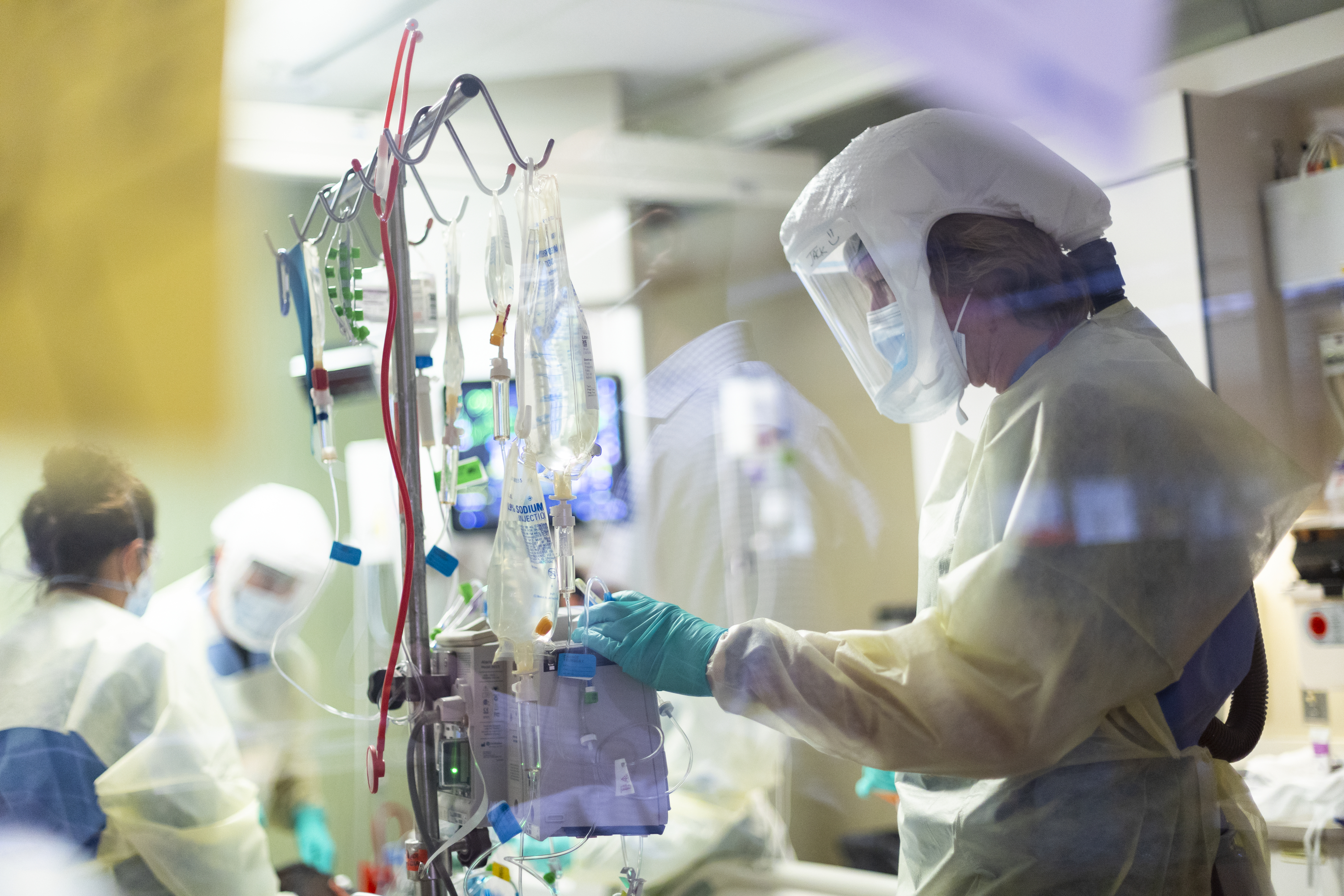 Nurse Jack Kingsley attends to a COVID-19 patient in the intensive care unit at St. Luke's Boise Medical Center in Boise on Aug. 31. Idaho public health leaders have activated "crisis standards of care" for the state's northern hospitals because there are more coronavirus patients than the institutions can handle.