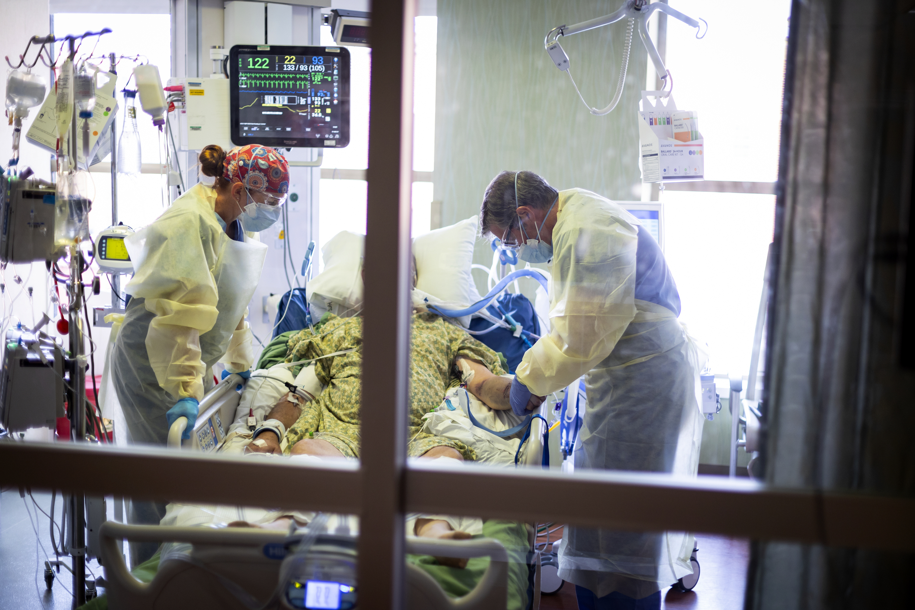 Dr. William Dittrich looks over a COVID-19 patient in the intensive care unit at St. Luke's Boise Medical Center in Boise on Aug. 31.