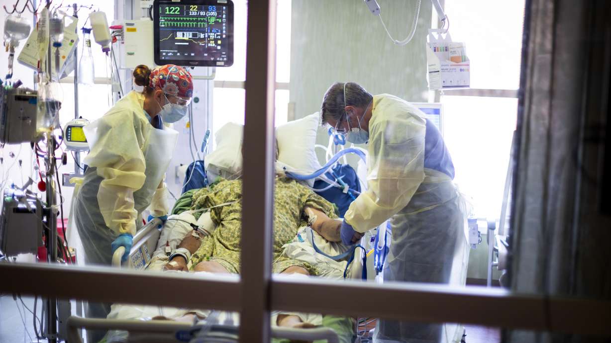 Dr. William Dittrich looks over a COVID-19 patient in the intensive care unit at St. Luke's Boise Medical Center in Boise on Aug. 31.