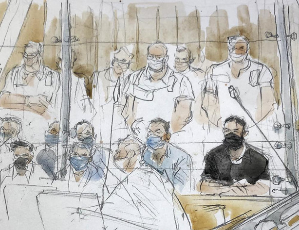 This sketch shows key defendant Salah Abdeslam, in black at right, in the special courtroom built for the 2015 attacks trial, Wednesday in Paris. The trial of 20 men accused in the Islamic State group's coordinated attacks on Paris in 2015 that transformed France opened Wednesday in a custom-built complex embedded within a 13th-century courthouse. Nine gunmen and suicide bombers struck within minutes of each other at several locations around Paris on Nov. 13, 2015, leaving 130 people dead and spreading fear across the nation.