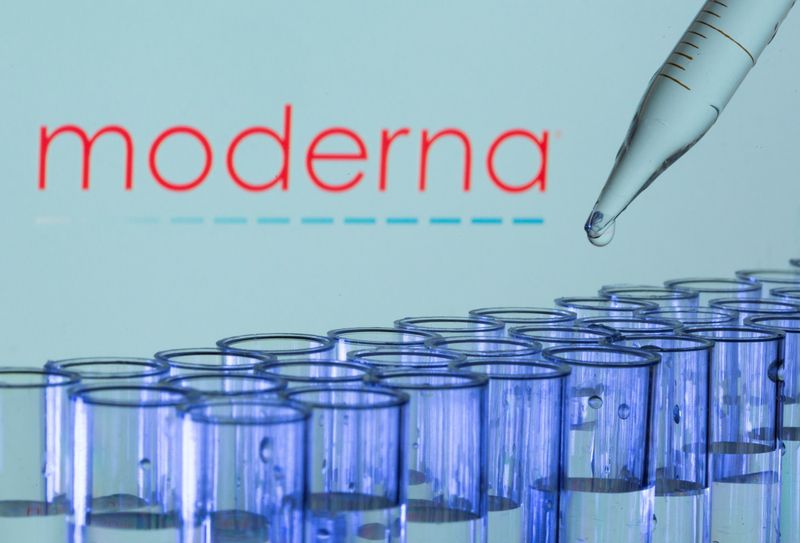Test tubes are seen in front of a displayed Moderna logo in this illustration taken May 21.