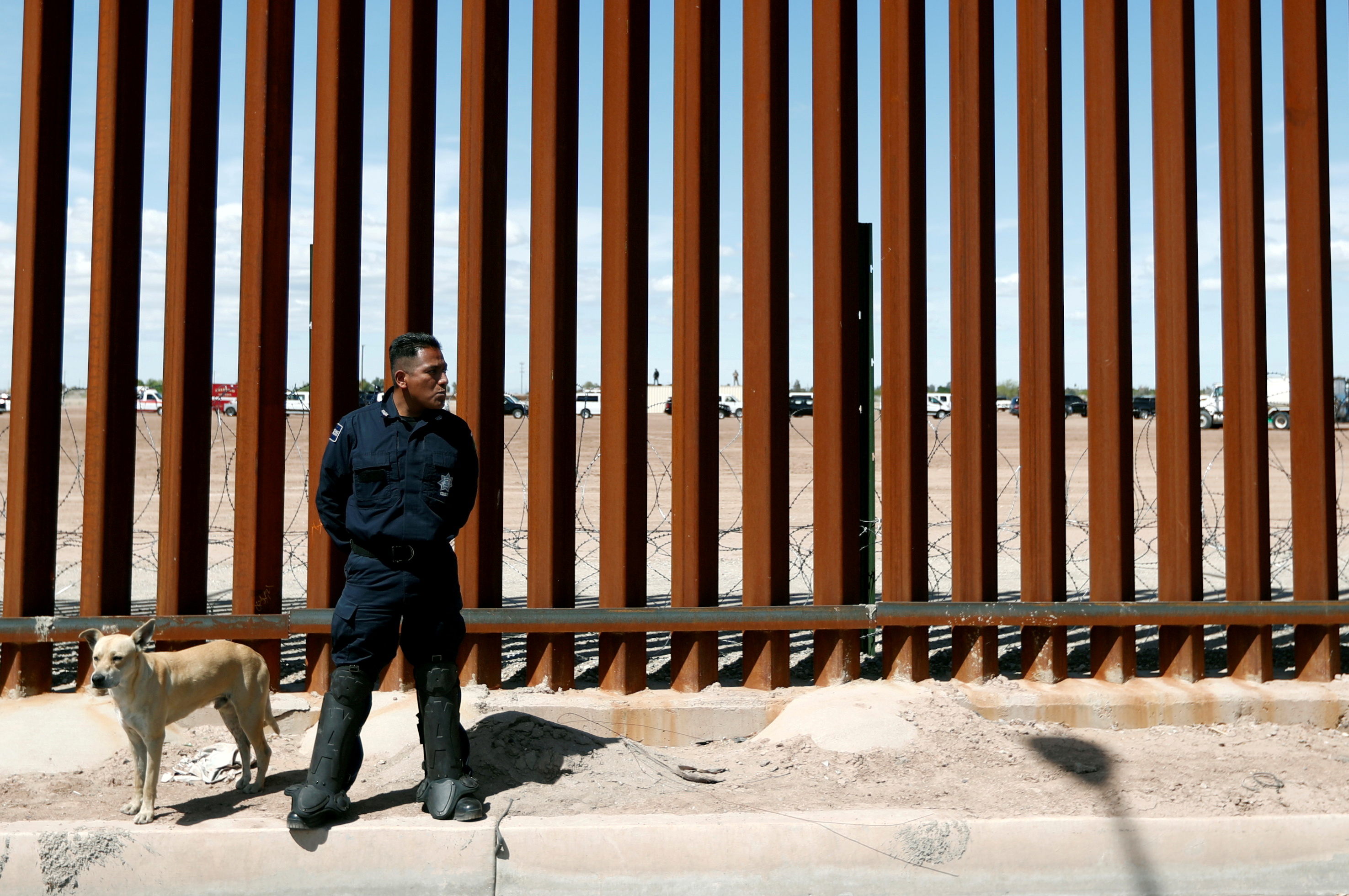 A Mexican federal police member stands guard during the visit of then-U.S. President Donald Trump to Calexico, California, as seen in Mexicali, Mexico, on April 5, 2019. The US and Mexico on Thursday will resume high-level economic talks for the first time in four years as the two sides seek to find common ground.