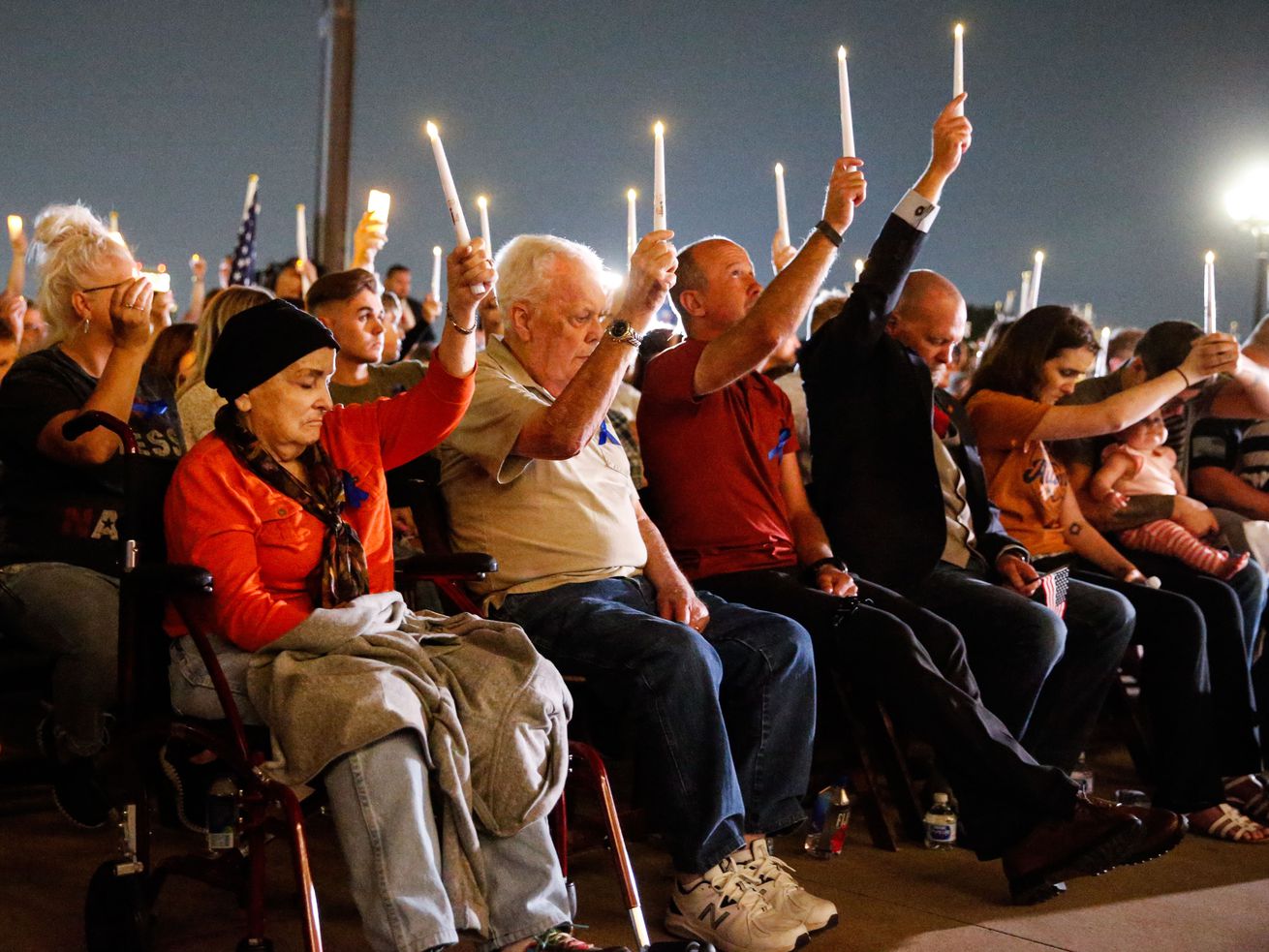 Family members attend a vigil to honor Marine Staff Sgt. Taylor Hoover at the Capitol in Salt Lake City on Aug. 29. Hoover was one of the 13 U.S. service members killed by the terrorist attack at the Kabul airport in Afghanistan. Hoover's father received an unexpected call from former President Donald Trump last week.