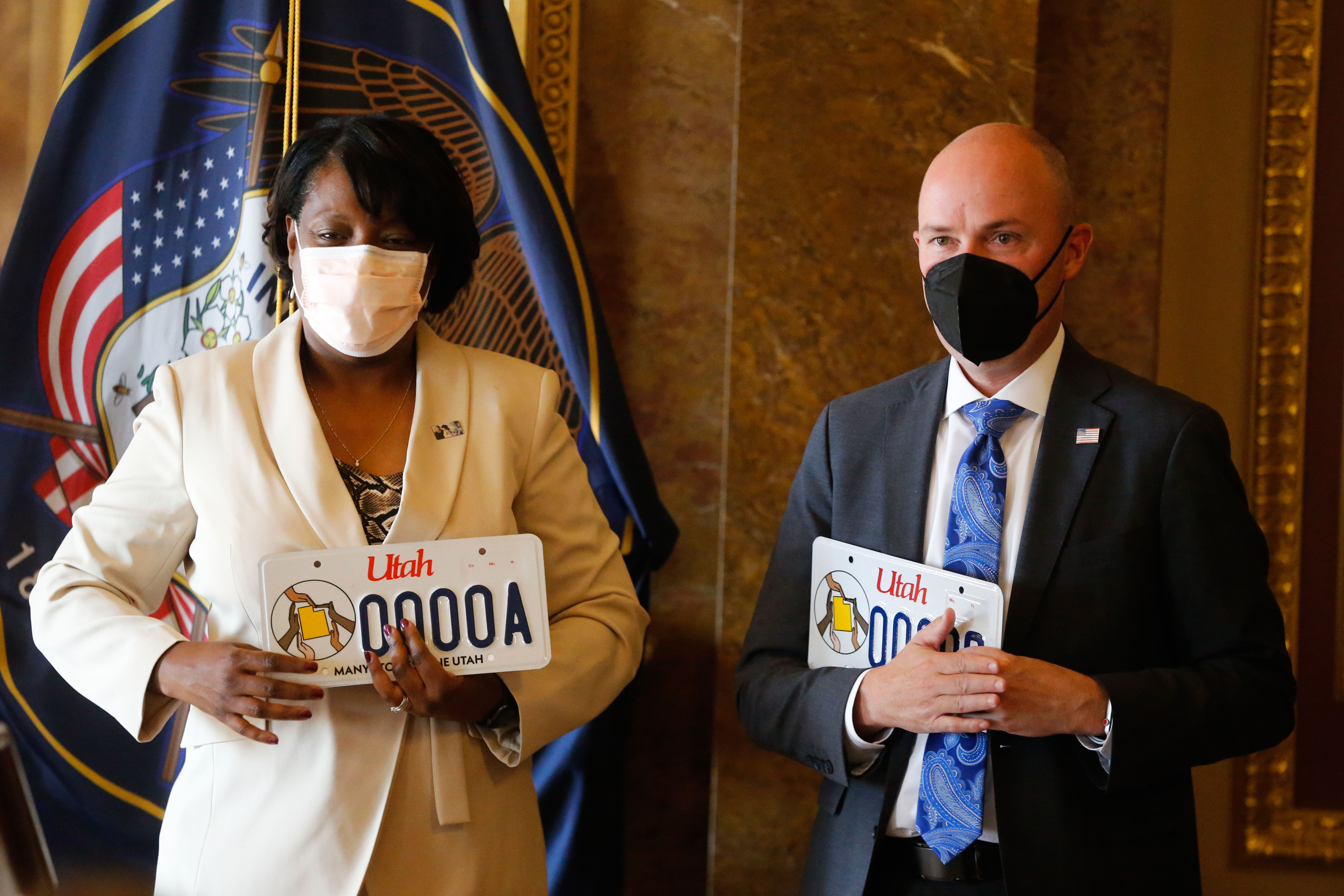 Rep. Sandra Hollins, D-Salt Lake City, left, and Utah Gov. Spencer Cox participate in the launch of new Utah license plate that celebrates Martin Luther King Jr. and diversity at the Capitol in Salt Lake City on Thursday.