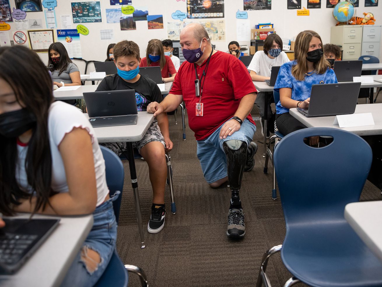 Bill Coleman, a sixth grade teacher, chats with Jerry Oyler during class at Nibley Park School in Salt Lake City on Aug. 24. When a student disobeys a school rule, there are opportunities for "teaching moments” to help bring them
into compliance.