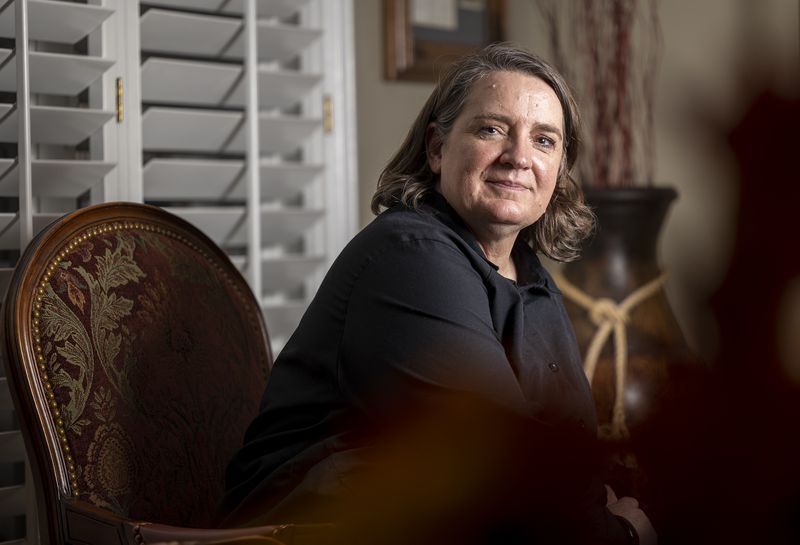 Andrea Wilko, who witnessed the second of two planes
that crashed into the World Trade Center towers in New York on
9/11, poses for photos at her parents’ home in Salt Lake City on Sept. 1.