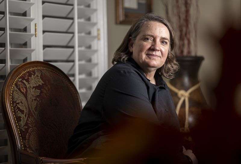 Andrea Wilko, who witnessed the second of two planes
that crashed into the World Trade Center towers in New York on
9/11, poses for photos at her parents’ home in Salt Lake City on Sept. 1.
