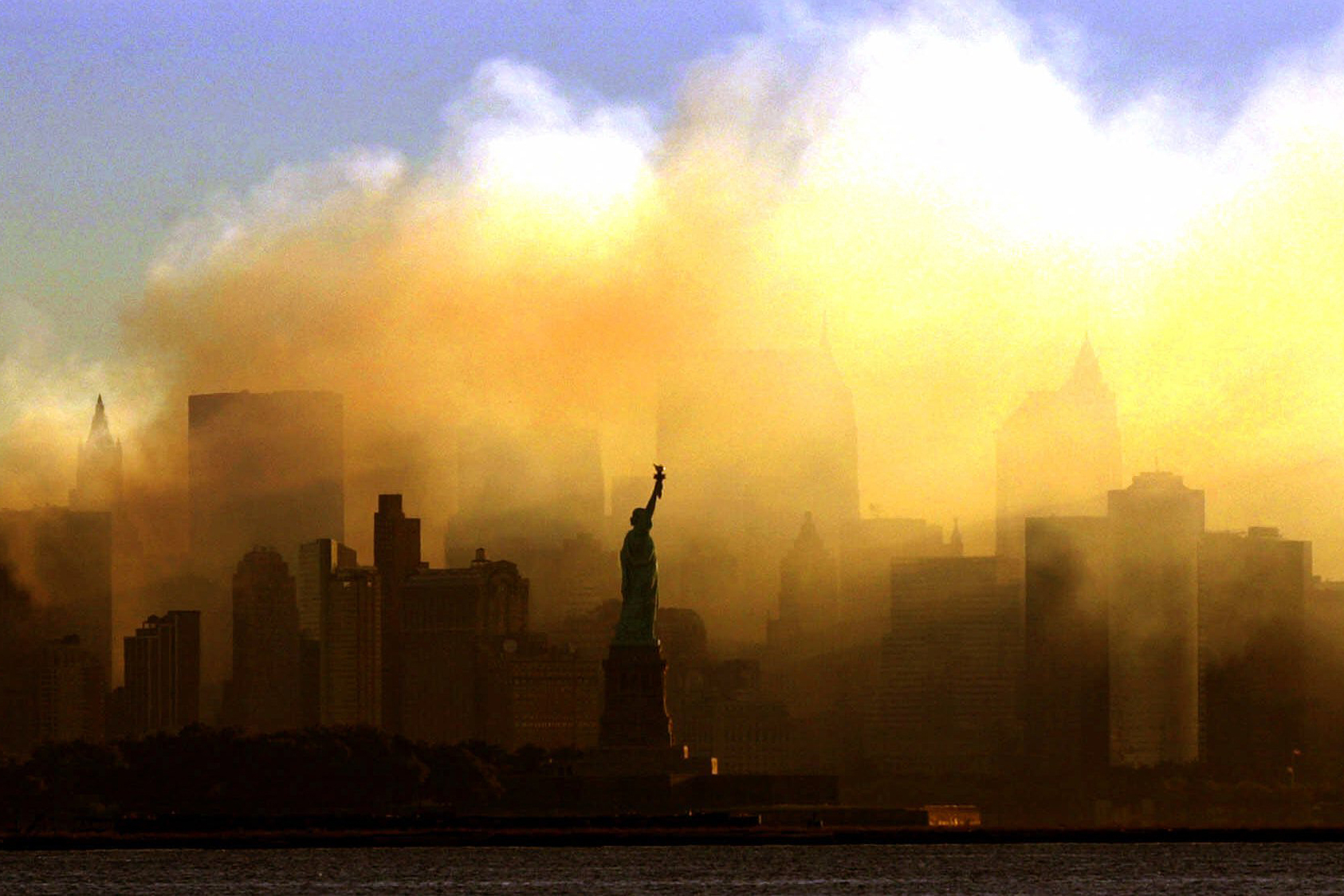 In this Sept. 15, 2001 photo, the Statue of Liberty stands in front of a smoldering lower Manhattan at dawn, seen from Jersey City, N.J. The Sept. 11, 2001 terrorist attacks on the United States nearly 20 years ago precipitated profound changes in America and the world. 