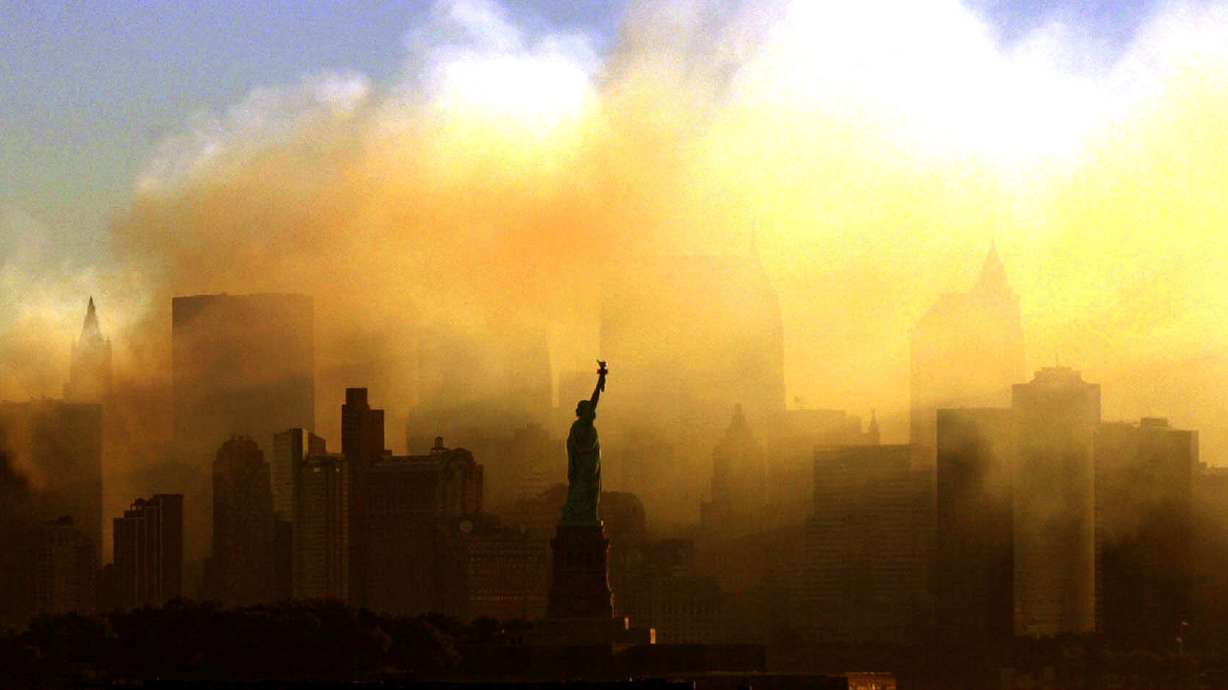 In this Sept. 15, 2001 photo, the Statue of Liberty stands in front of a smoldering lower Manhattan at dawn, seen from Jersey City, N.J. The Sept. 11, 2001 terrorist attacks on the United States nearly 20 years ago precipitated profound changes in America and the world.