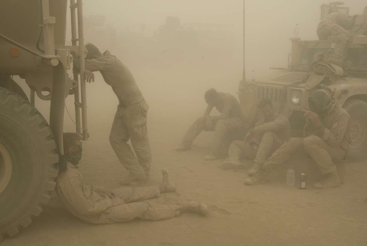 U.S. Marines from the 24th Marine Expeditionary Unit try to take shelter from a sand storm at forward operating base Dwyer in the Helmand province of southern Afghanistan on Wednesday, May 7, 2008.