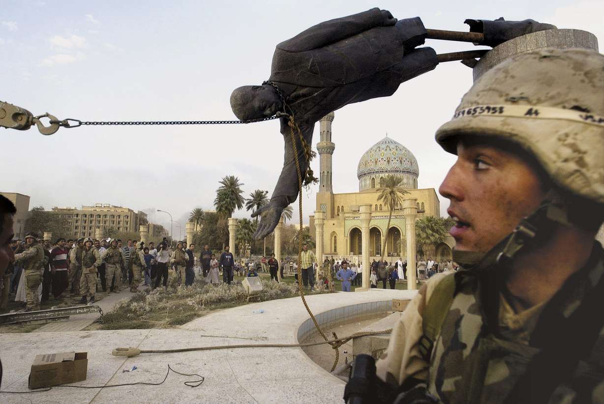 Iraqi civilians and U.S. soldiers pull down a statue of Saddam Hussein in downtown Baghdad, on April 9, 2003 file photo. The U.S. invaded Iraq on false claims that Hussein was hiding weapons of mass destruction.