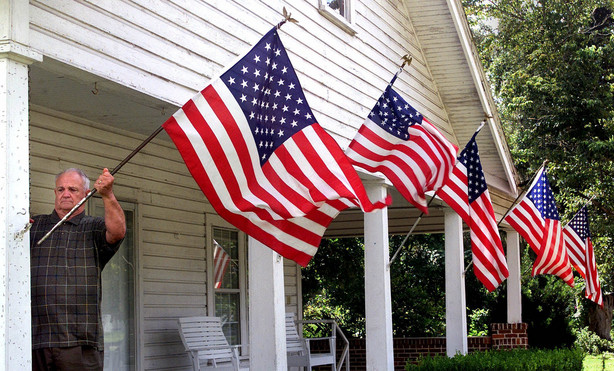 Liberty County resident Rev. M. Timonthy Elder, Sr., retired, repositions one of his wind-blown U.S. flags in Bristol, Fla, on Thursday, Sept. 13, 2001. Rev. Elder displayed the flags as a show of his family's support for America following terrorist attacks in New York City and Washington two days earlier.
