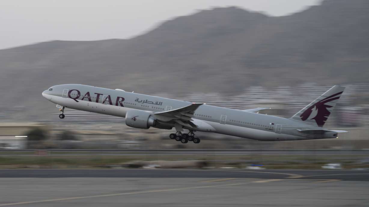 A Qatar Airways aircraft takes off with foreigners from the airport in Kabul, Afghanistan, Thursday. Thousands of at-risk Afghans who had helped the United States are still stranded in their homeland.