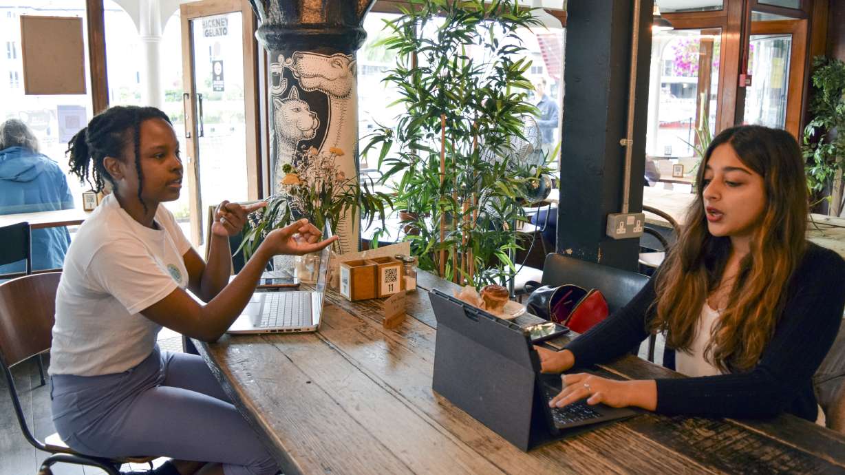 Sonya Barlow, right, CEO of Like Minded Females Network, speaks to Rebekah Ingram, her intern, at White Mulberries, a coffee shop in London, Thursday, Sep. 2. Many young workers around the world have entered the workforce and begun their careers during the pandemic working entirely remotely. Like Minded Females Network is a social enterprise that helps young women set up businesses and other ventures, without the use of a fixed office space.