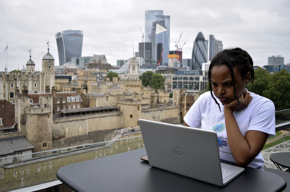 Rebekah Ingram, an intern at Like Minded Females Network, works on her laptop at WeWork, a co-operative work space in London, Thursday, Sep. 2. Many young workers around the world have entered the workforce and begun their careers during the pandemic working entirely remotely.