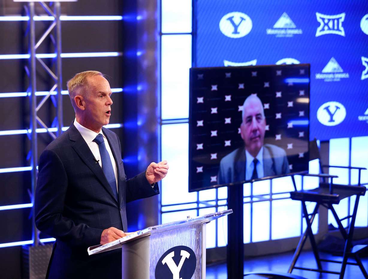 BYU athletic director Tom Holmoe speaks at a press conference where the school announced it accepted an invitation to join the Big 12 Conference in Provo on Friday, Sept. 10, 2021. At right, Big 12 commissioner Bob Bowlsby joins via video conference. BYU will play all sports provided by the Big 12 except for equestrian, rowing and wrestling. Men’s volleyball will continue to play in the Mountain Pacific Sports Federation, as the Big 12 does not offer the sport.