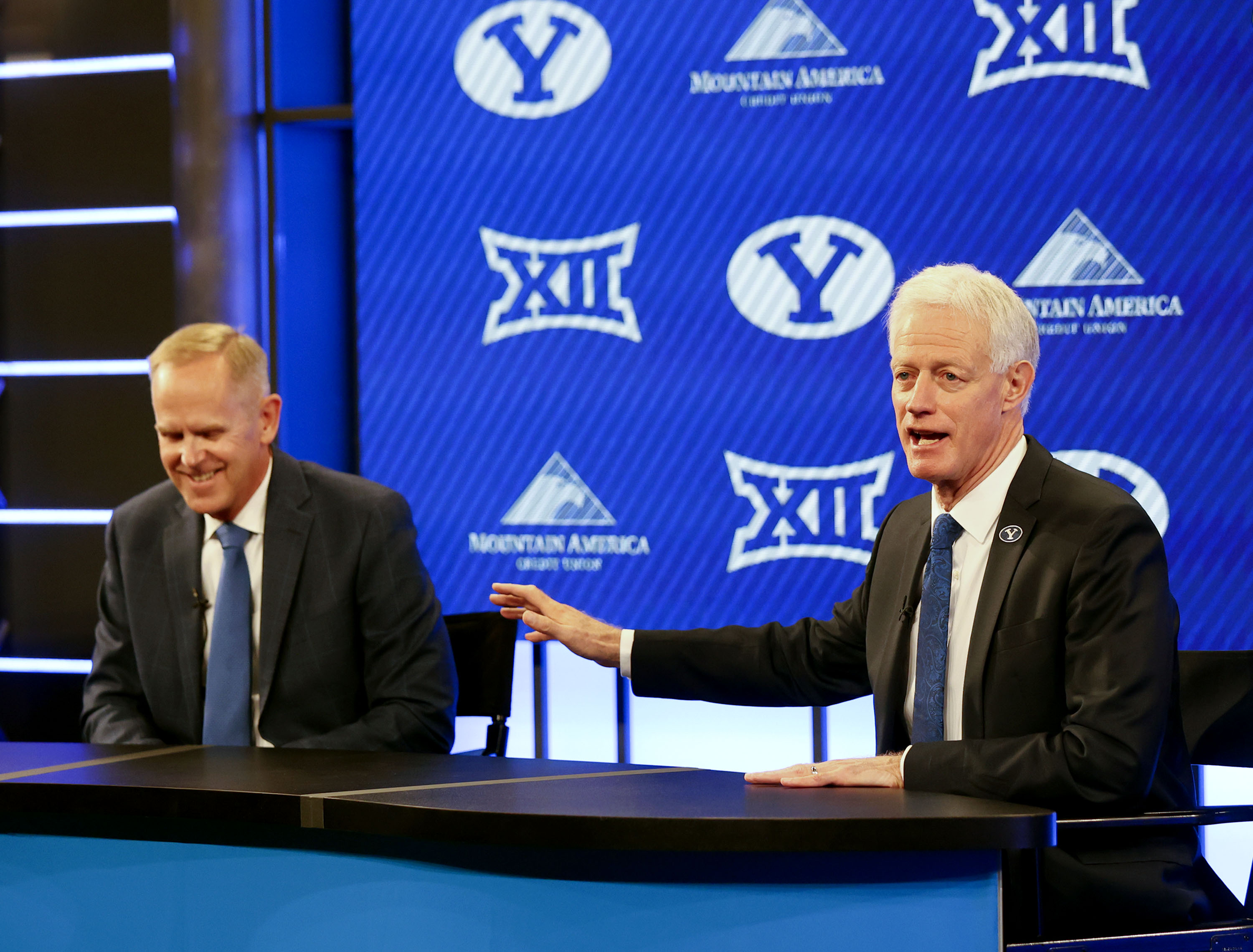 BYU president Kevin Worthen, right, speaks about athletic director Tom Holmoe, left, during a press conference announcing that BYU has accepted an invitation to the Big 12 Conference at BYU in Provo on Friday, Sept. 10, 2021. BYU will play all sports provided by the Big 12 except for equestrian, rowing and wrestling. Men’s volleyball will continue to play in the Mountain Pacific Sports Federation, as the Big 12 does not offer the sport.
