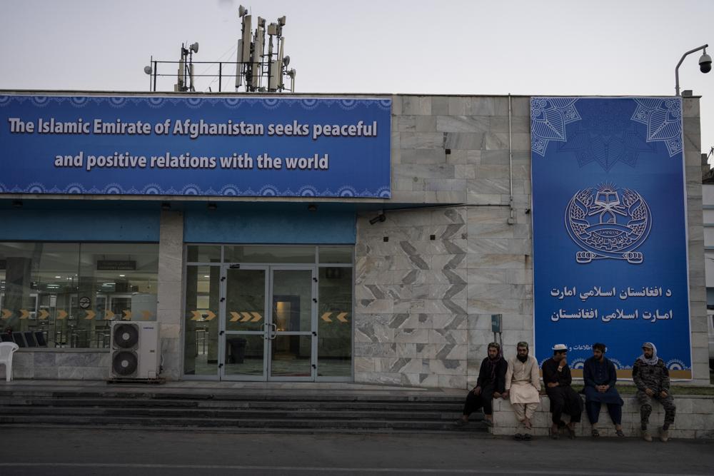 In this Thursday photo, Taliban personnel and airport staffers sit at the airport in Kabul, Afghanistan. U.S. veterans, lawmakers and others say the relaunch of evacuation flights from Kabul has done little to soothe fears that the U.S. might abandon countless Afghan allies who risked their lives working alongside American troops.