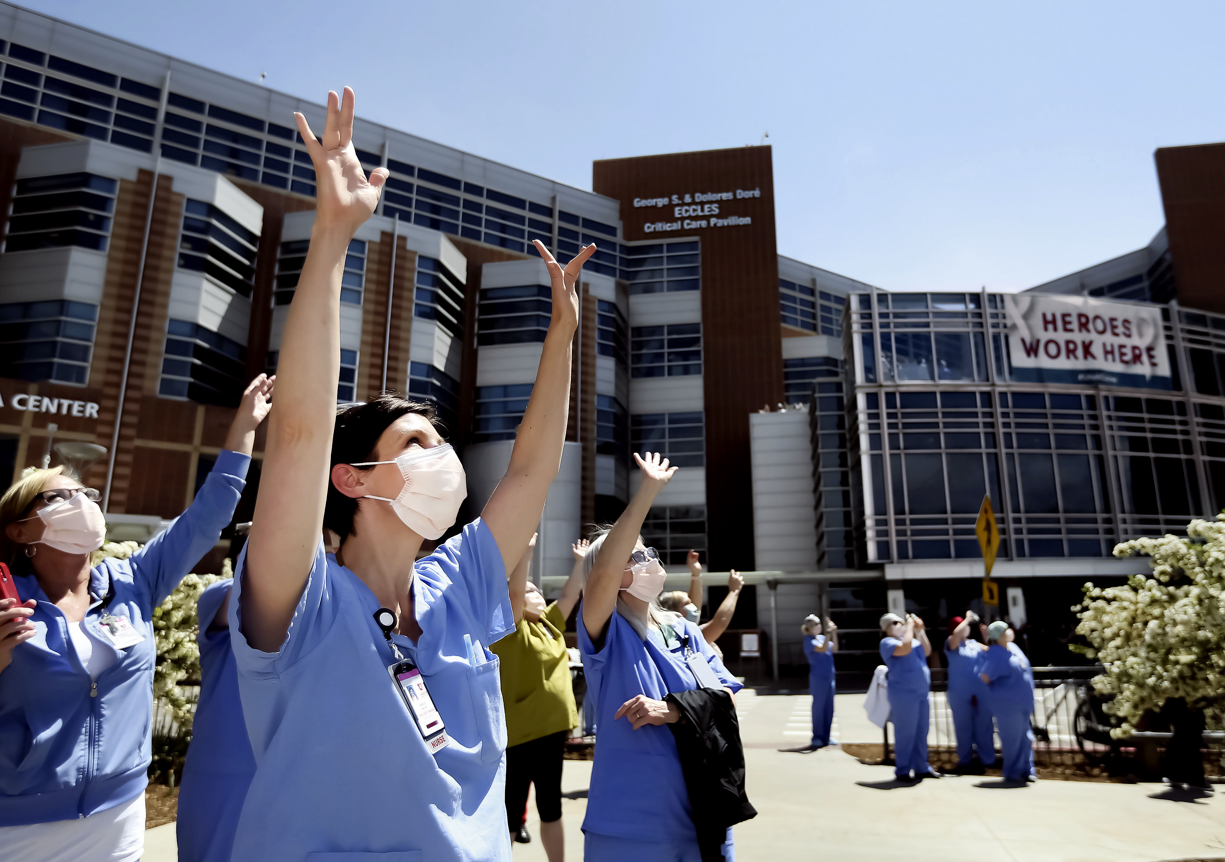 Nikole Ihler, a nurse in the labor and delivery department at University of Utah Hospital, waves as Hill Air Force Base’s 388th Fighter Wing fly in formation over the hospital in Salt Lake City on April 30, 2020. The flyover was a “thank you” to health care workers, first responders, military members and essential personnel.